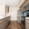 a kitchen with a sink, stove and fridge